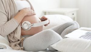 Pregnant woman having her baby listening to music